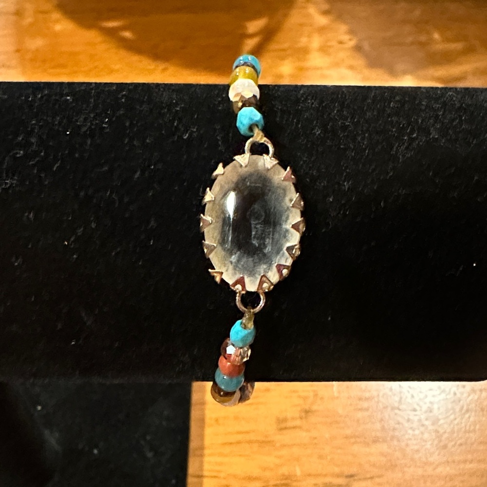 Multi-Color Beaded Bracelet with Large Oval Quartz Crystal Centerpiece.